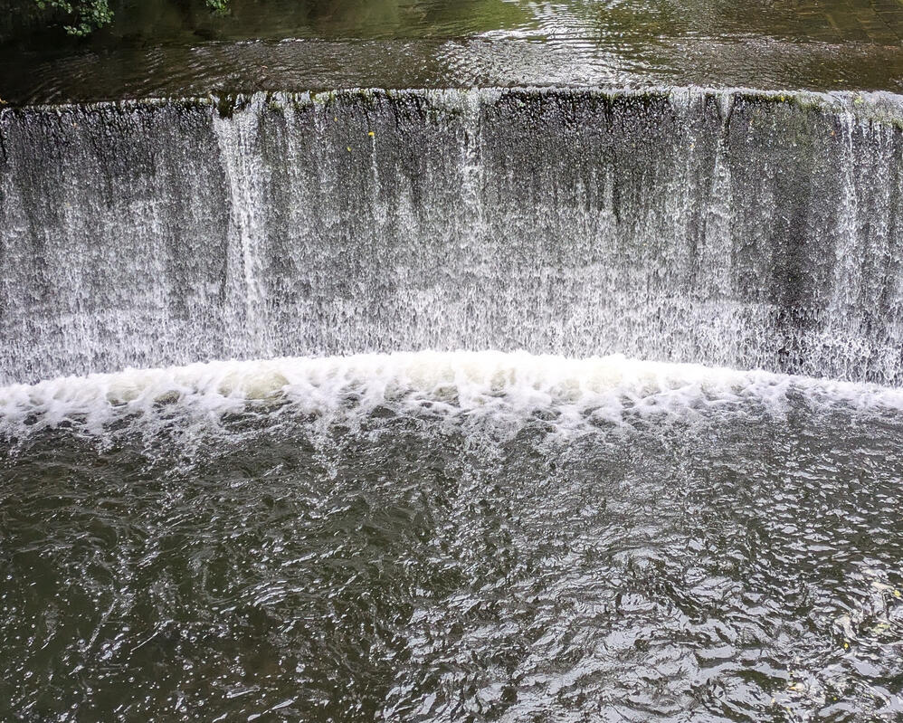 Water over a tall, vertical weir on the River Dane, Winkle